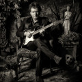 Drew Nelson with Stratocaster guitar black and white portrait.